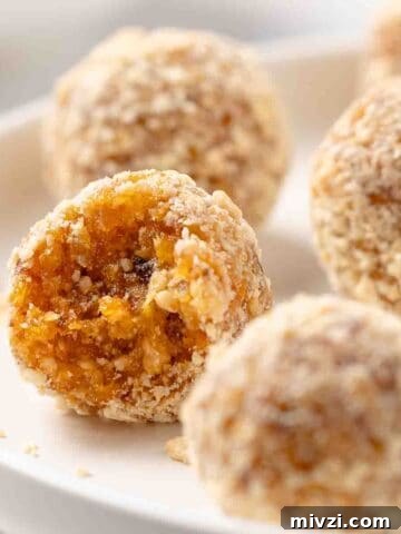 apricot balls on plate with one bite taken out.