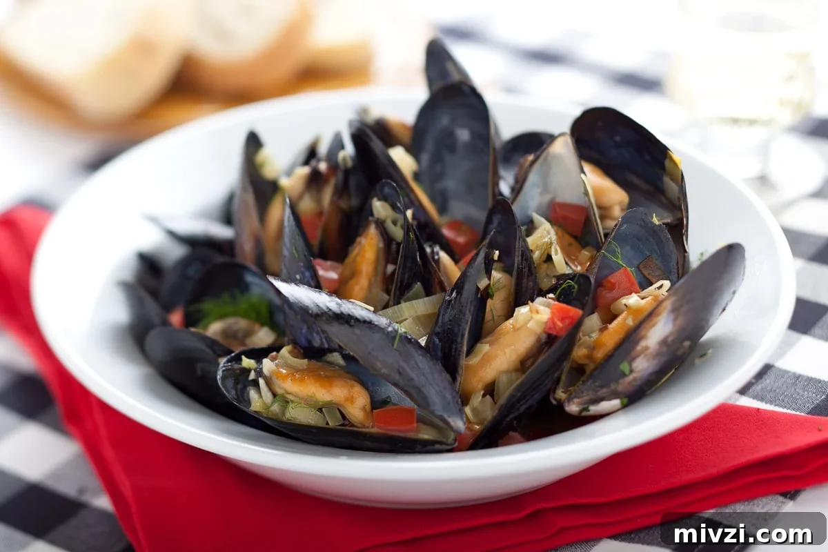 Mussels in White Wine (Moules Marinières) — Classic French Recipe 2 Black shell steamed mussels with red napkin.