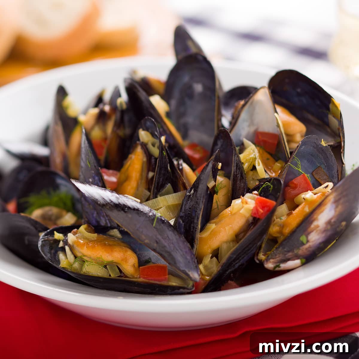 Mussels in White Wine (Moules Marinières) — Classic French Recipe 3 Steamed mussels in a white bowl.