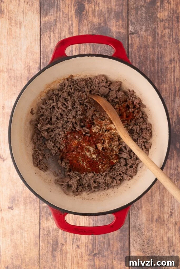 Authentic Texas Chili Recipe for Classic Frito Pie 4 browning ground beef in dutch oven