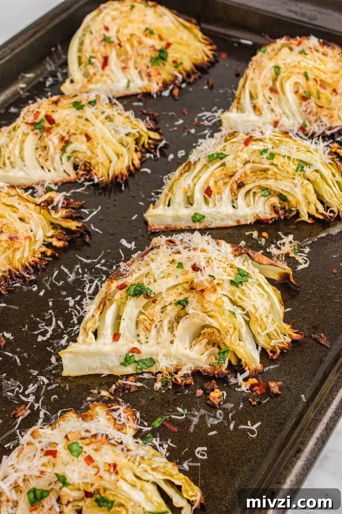 Crispy Roasted Cabbage Wedges with Garlic and Parmesan 3 Garlic parmesan roasted cabbage wedges on sheet pan.