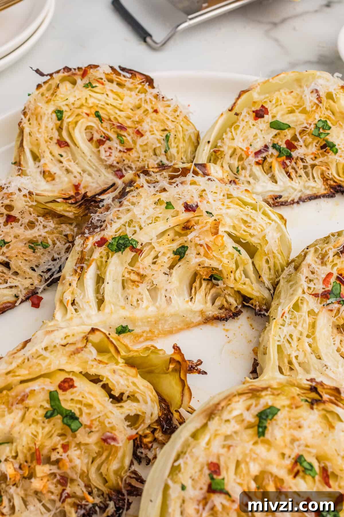 Crispy Roasted Cabbage Wedges with Garlic and Parmesan 8 Overhead view of roasted cabbage wedges with garlic, parmesan cheese, and red pepper flakes.
