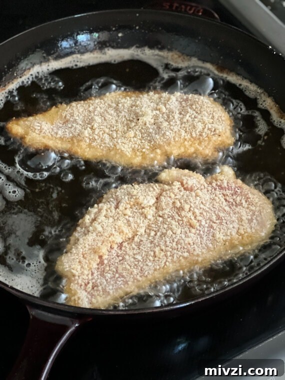 Crispy Pan-Fried Chicken Cutlets with Lemon Garlic Sauce 6 Frying chicken cutlets in a skillet