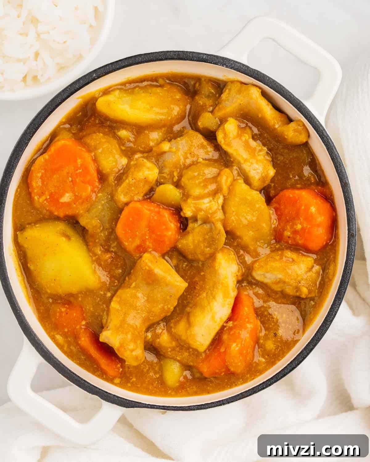 Authentic Japanese Chicken Curry Recipe for Rich, Comforting Flavor 3 pot of chicken, carrot and potato japanese curry with bowl of white rice.