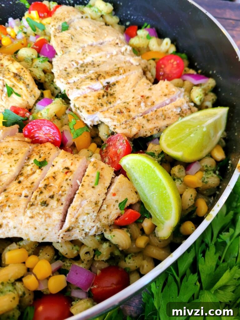 Summer Tomato and Corn Pasta Salad Recipe 3 Colorful tomato corn pasta salad with pesto chicken and jalapeños in a large serving bowl