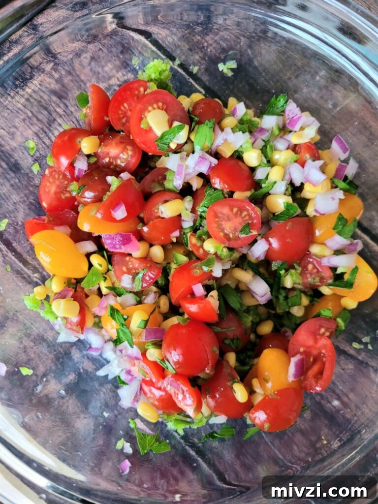 Summer Tomato and Corn Pasta Salad Recipe 7 bowl of mixed veggies like grape tomatoes, red onion, jalapeno, corn and lime