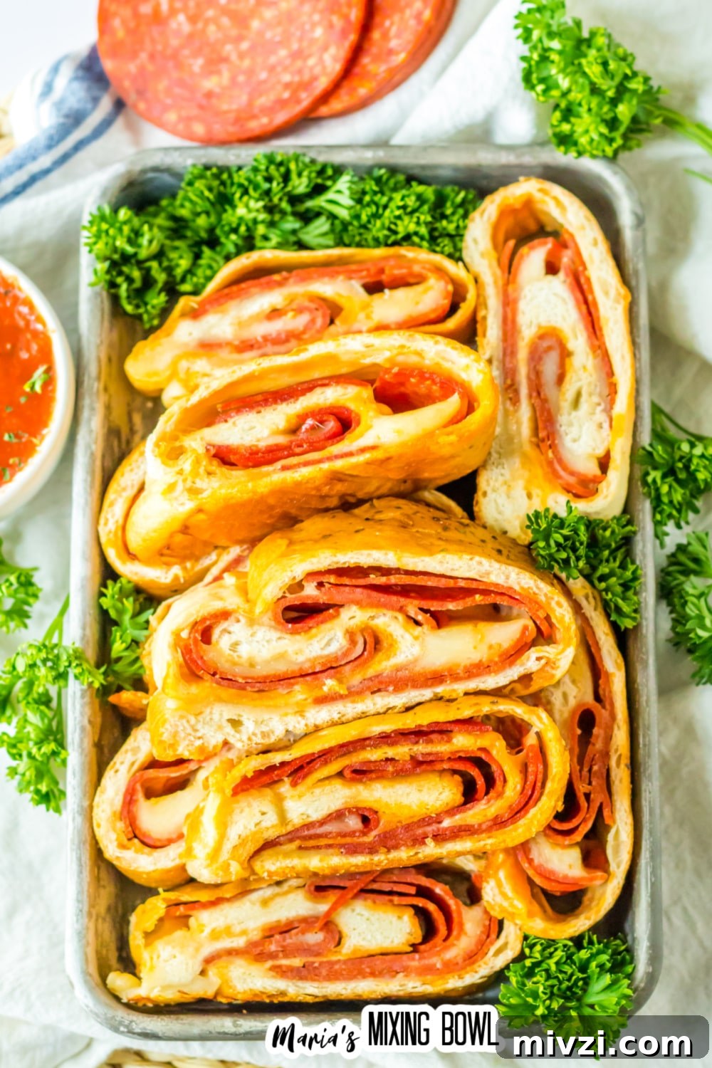 Pepperoni-Stuffed Bread: Cheesy, Savory Pull-Apart Loaf 2 slices of stuffed pepperoni bread on a metal serving tray.