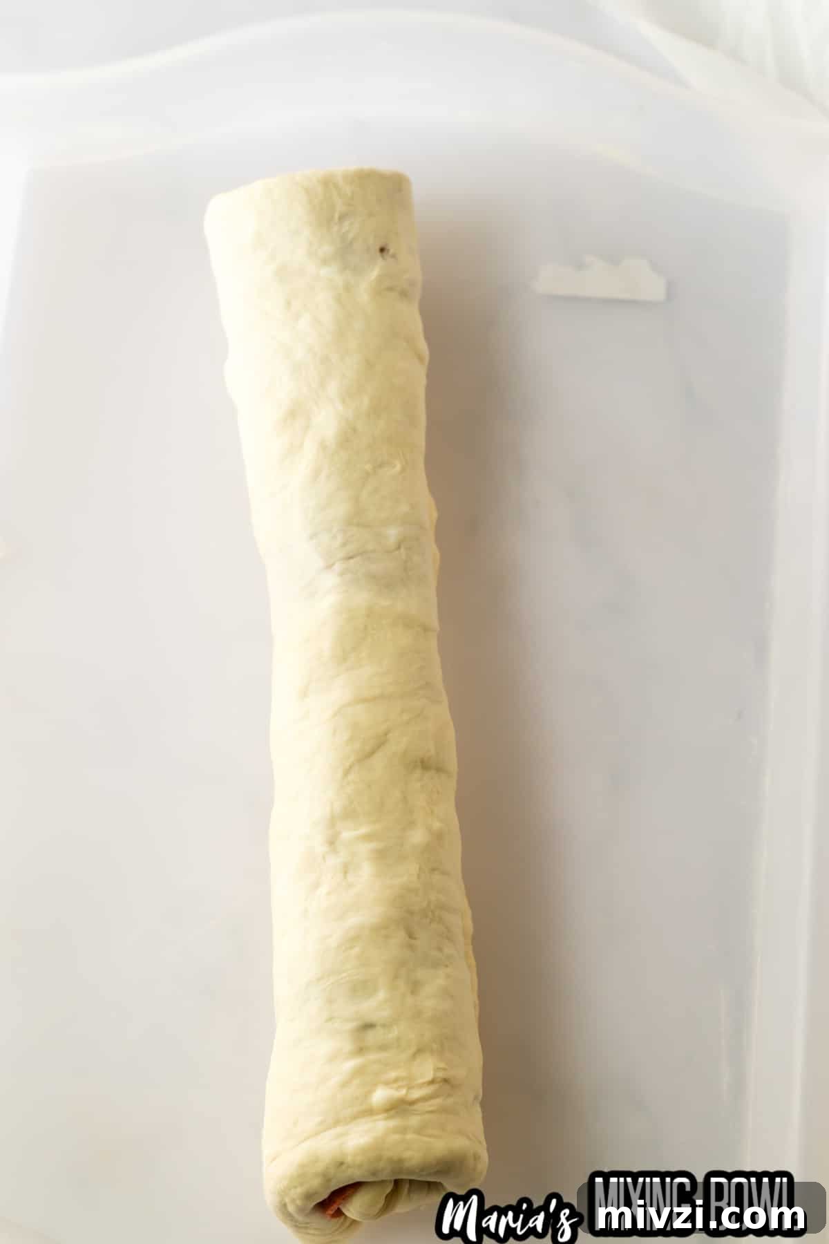 Pepperoni-Stuffed Bread: Cheesy, Savory Pull-Apart Loaf 6 roll of stuffed pepperoni bread on a parchment baking sheet