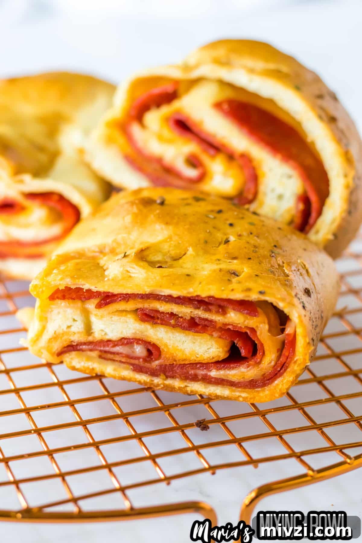Pepperoni-Stuffed Bread: Cheesy, Savory Pull-Apart Loaf 8 slices of stuffed pepperoni bread cooling on a wire rack.