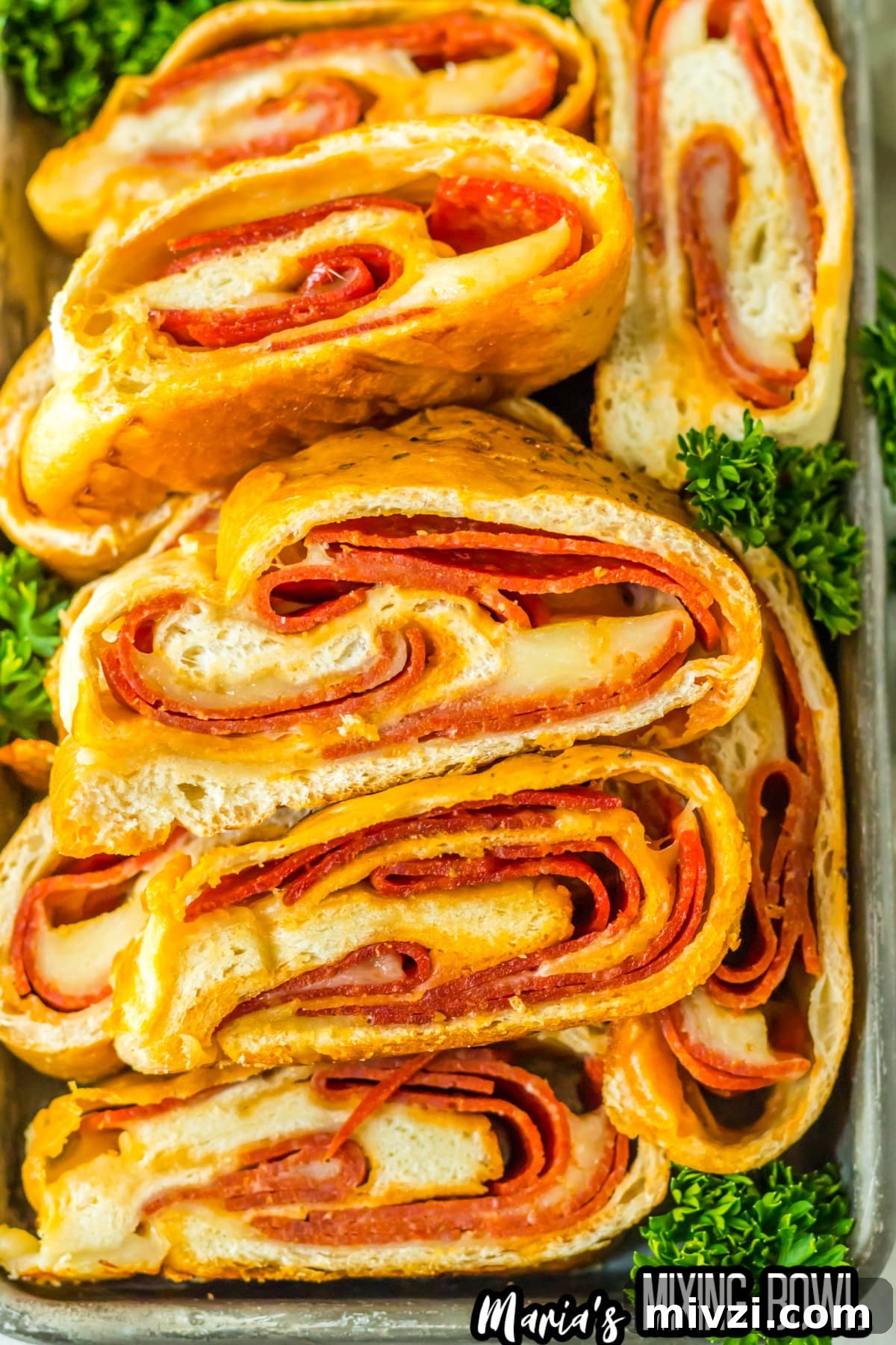 Pepperoni-Stuffed Bread: Cheesy, Savory Pull-Apart Loaf 9 slices of stuffed pepperoni bread on a metal serving tray.