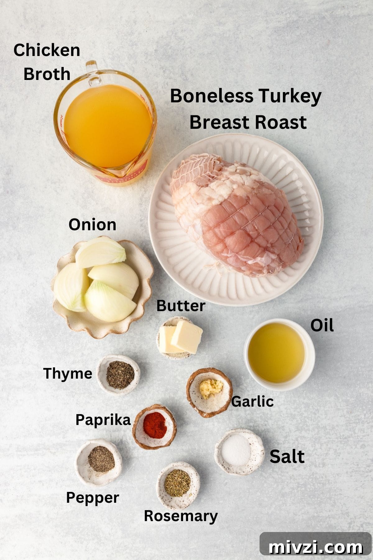 Chicken broth in a glass measuring cup, with raw boneless turkey breast roast, onion, butter, and spices on a light countertop.