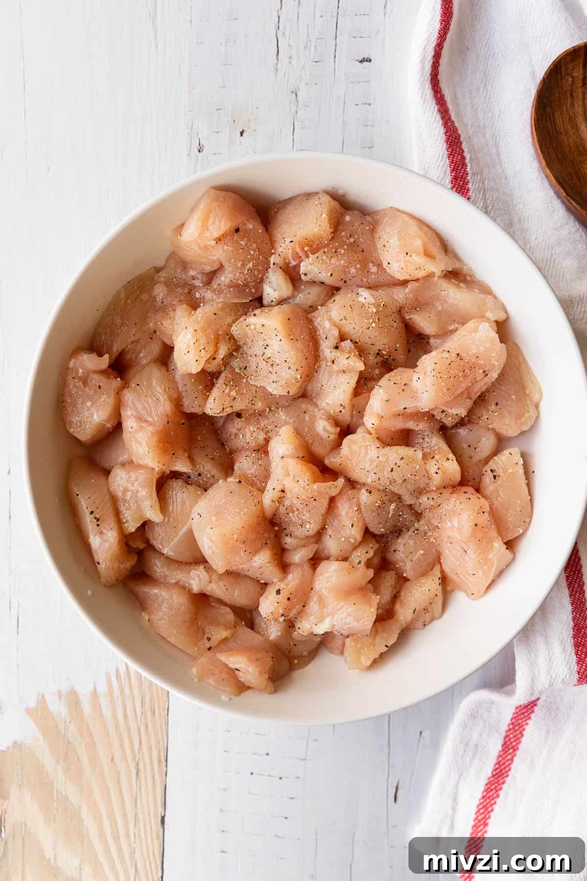 Brazilian-Style Chicken Stroganoff Recipe for Dinner 4 a bowl of raw chicken breast cut into small pieces