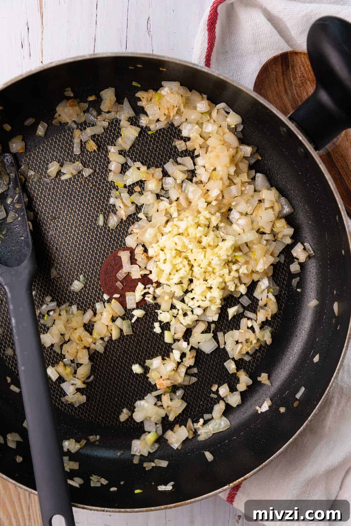 Brazilian-Style Chicken Stroganoff Recipe for Dinner 6 a skillet with onions and garlic cooking