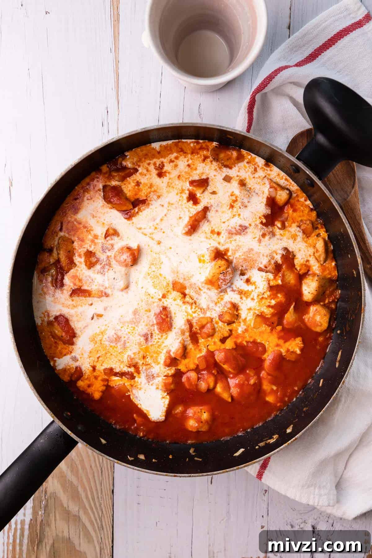 Brazilian-Style Chicken Stroganoff Recipe for Dinner 8 a skillet with chicken, tomato sauce and cream