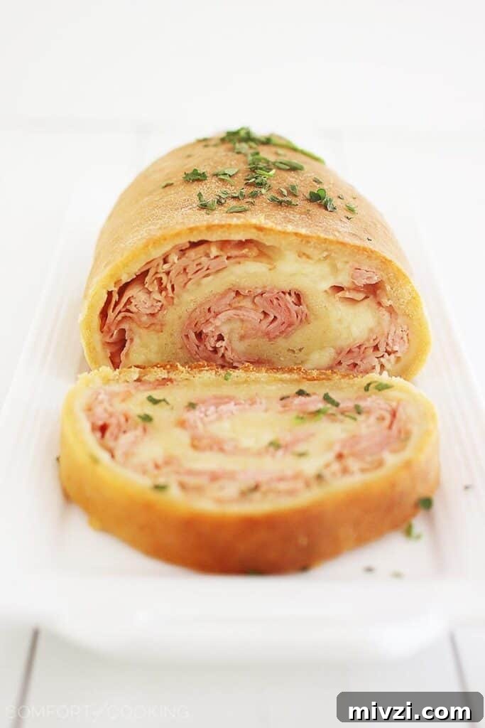Cold and Room-Temperature Appetizers: 30 Make-Ahead Ideas 19 ham and cheese roll ups sliced on a plate.