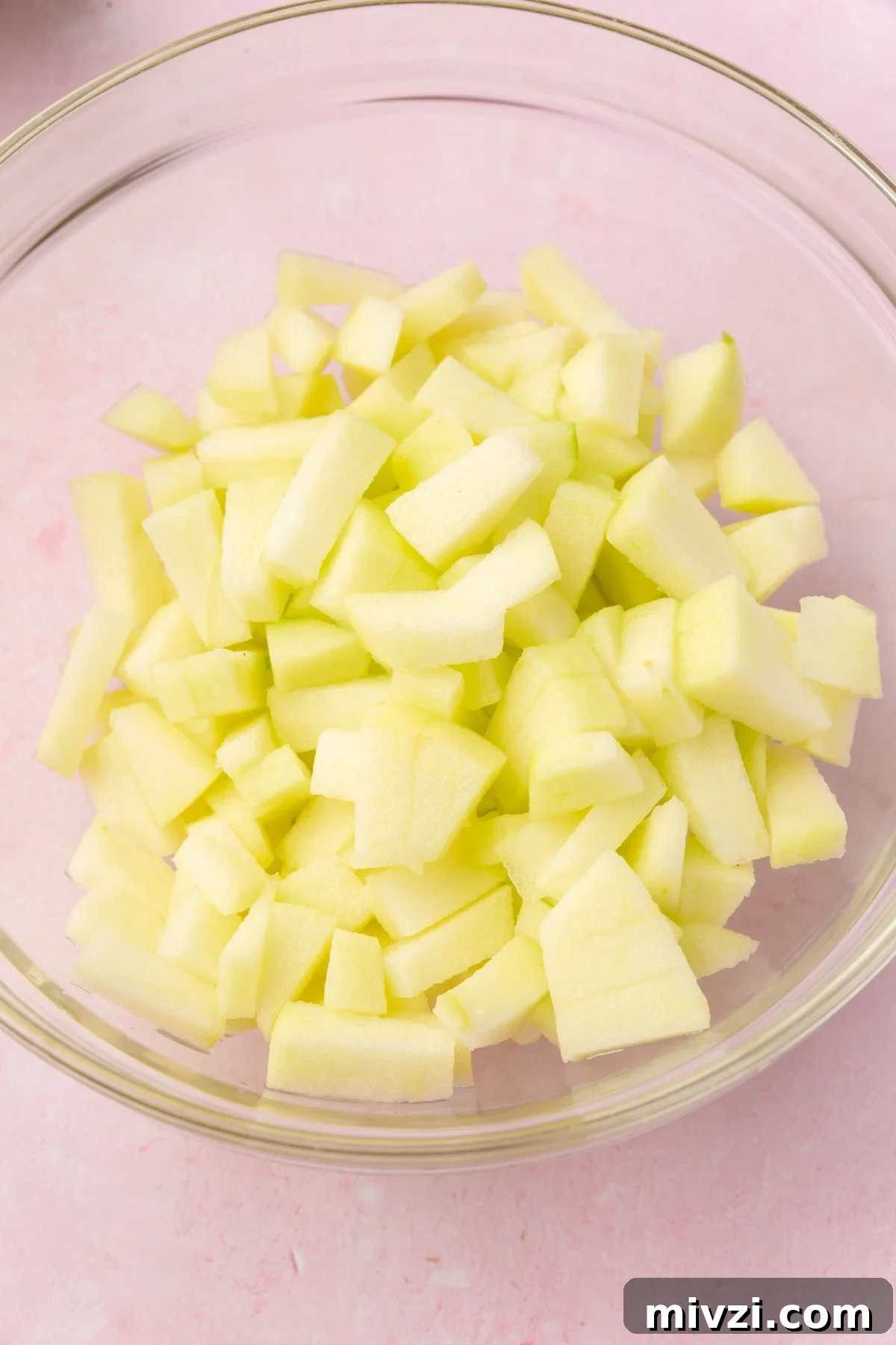Crispy Gluten-Free Apple Fritters Recipe 4 Bowl of diced green apples prepared for making gluten-free apple fritters.