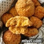 Close up of a Dorothy's cornbread drop biscuit with a bite out of it.
