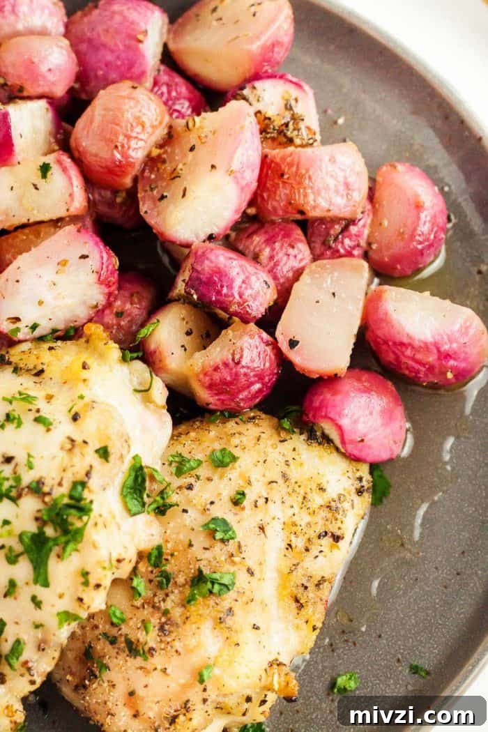 overhead view of sheet pan chicken thighs cooked next to seasoned roasted radishes