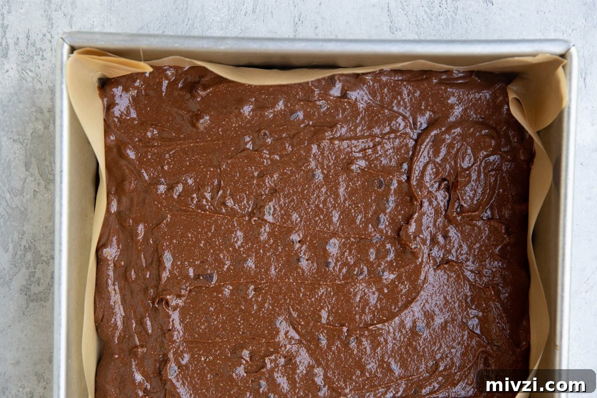 Baking dish full of brownie batter, ready to go into the oven.