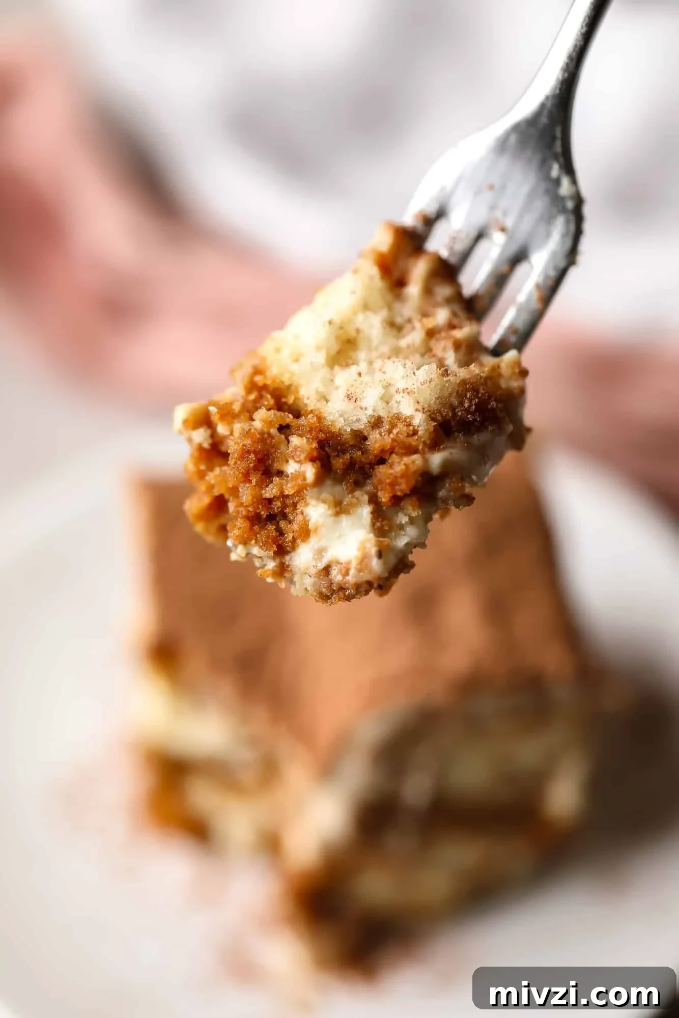 close up on a bite of vegan tiramisu on a fork.