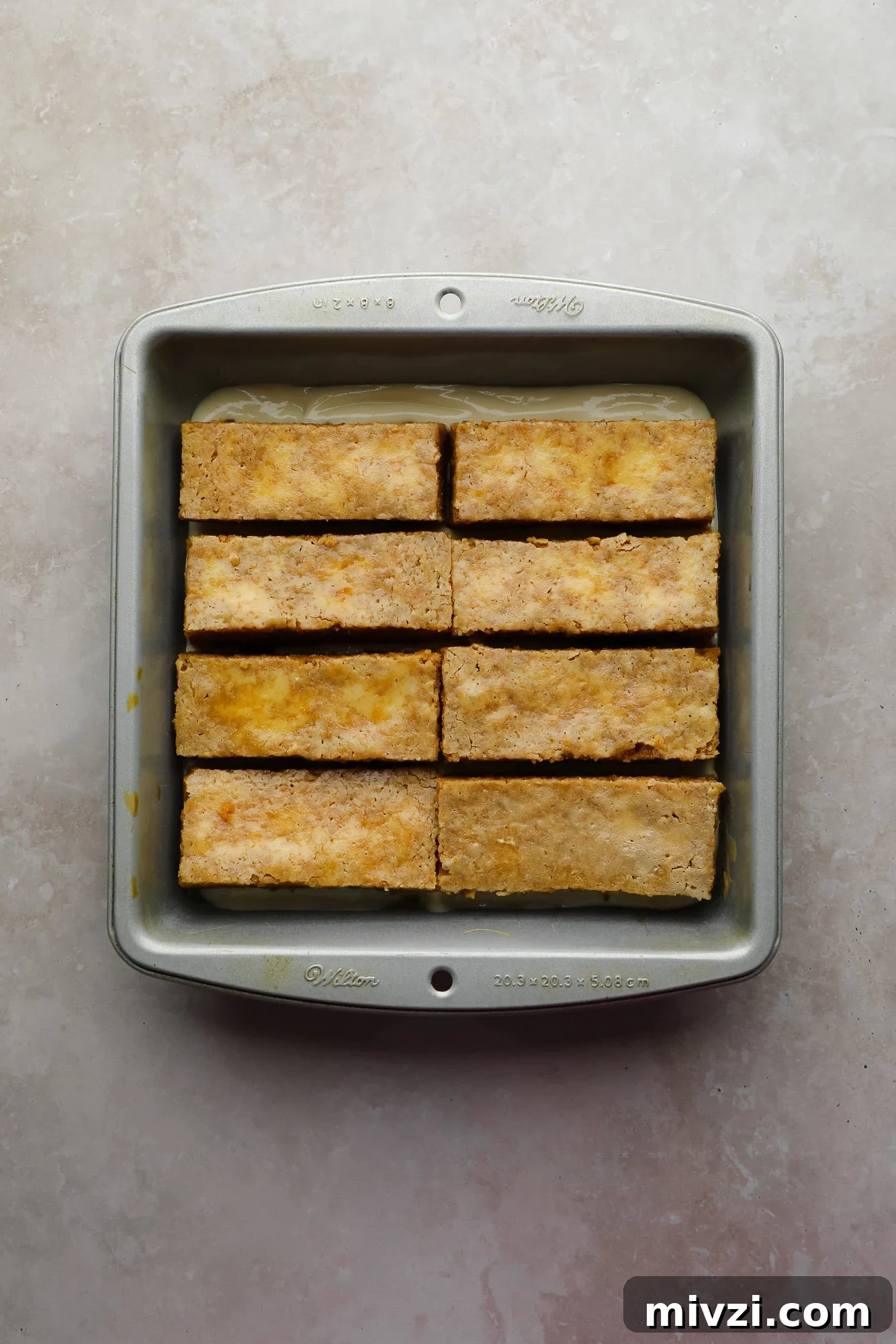 vegan vanilla cake strips soaked in espresso in a baking dish.
