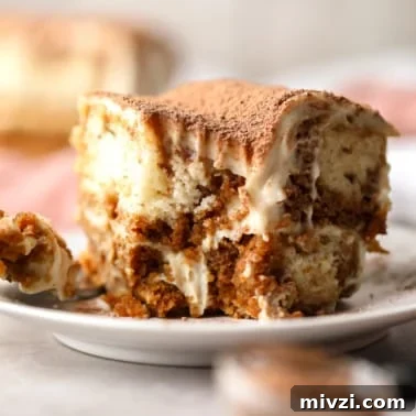 close up on a slice of vegan tiramisu with a bite missing.