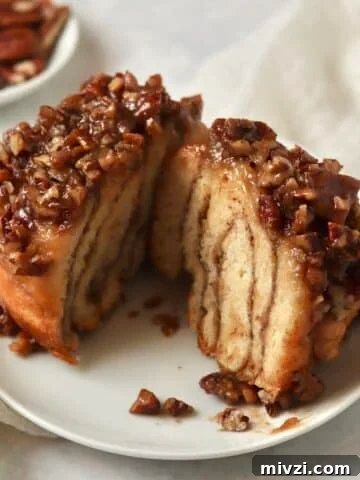 Single serve pecan sticky bun on a plate.