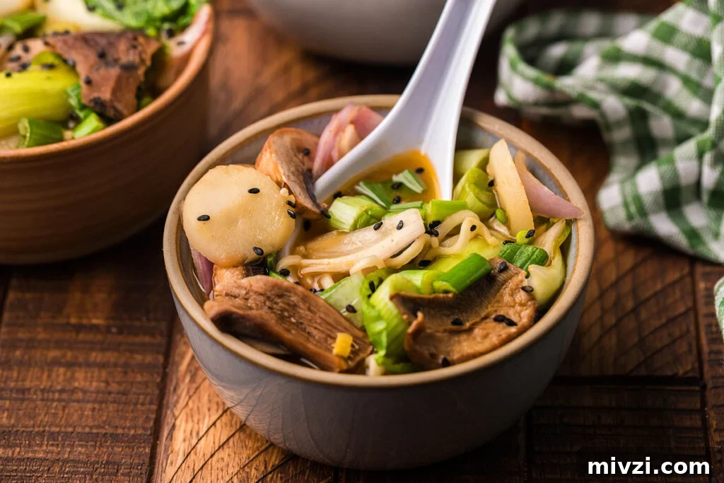 29 Cozy One-Pot Fall Dinners That Cut the Cleanup 12 Ramen loaded with mushrooms and vegetables served in a bowl with a spoon.