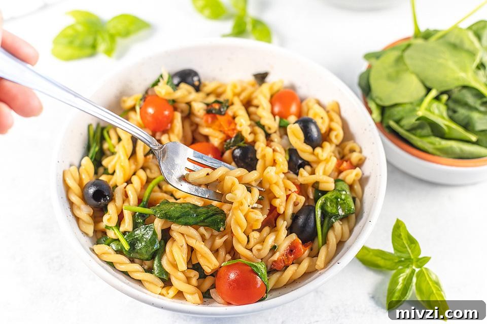 29 Cozy One-Pot Fall Dinners That Cut the Cleanup 17 Pasta and spinach with tomatoes in a pot.