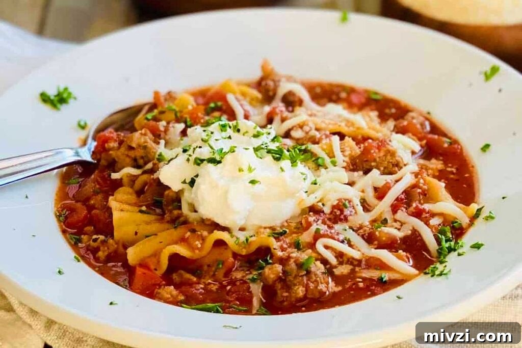 29 Cozy One-Pot Fall Dinners That Cut the Cleanup 27 A bowl of creamy lasagna soup with cheese and ricotta on top.