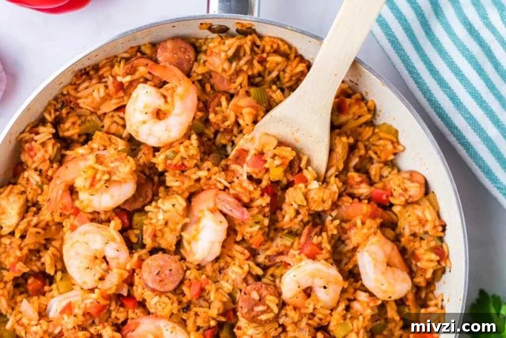 29 Cozy One-Pot Fall Dinners That Cut the Cleanup 28 A skillet of jambalaya with a serving spoon in it.